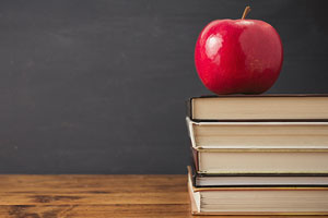 An apple on a stack of books